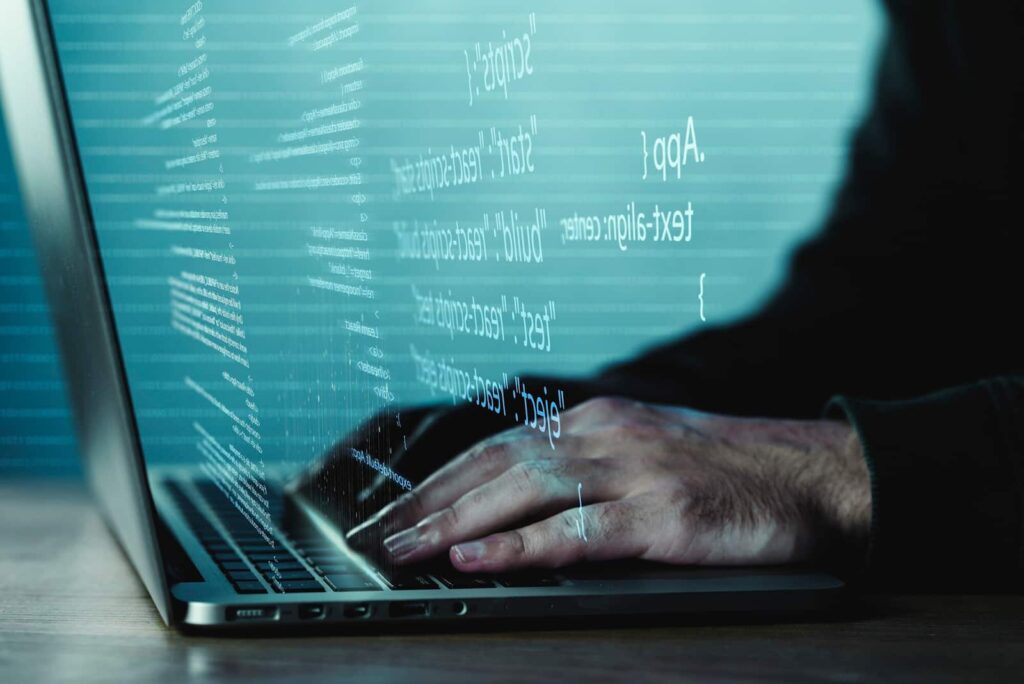 Programming background with person working with codes on computer
